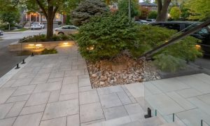 custom retaining wall with glass railings lighting